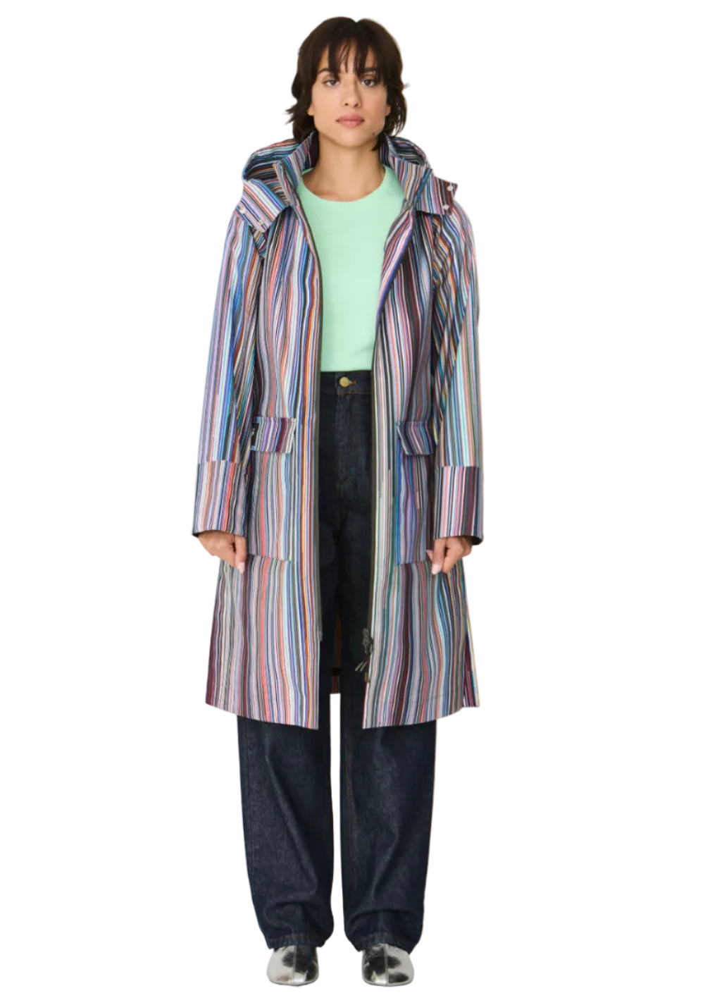 Model wearing the striped Kresua Jacket in grems by SKFK, a stylish knee-length raincoat