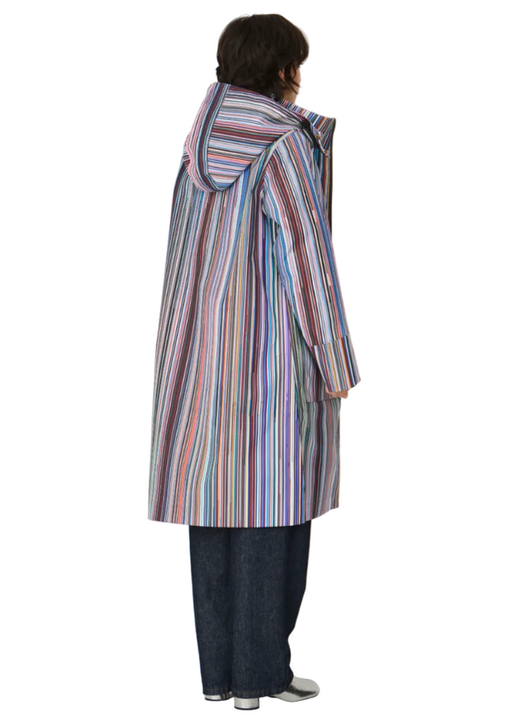 back view of Model wearing the striped Kresua Jacket in grems by SKFK, a stylish knee-length raincoat