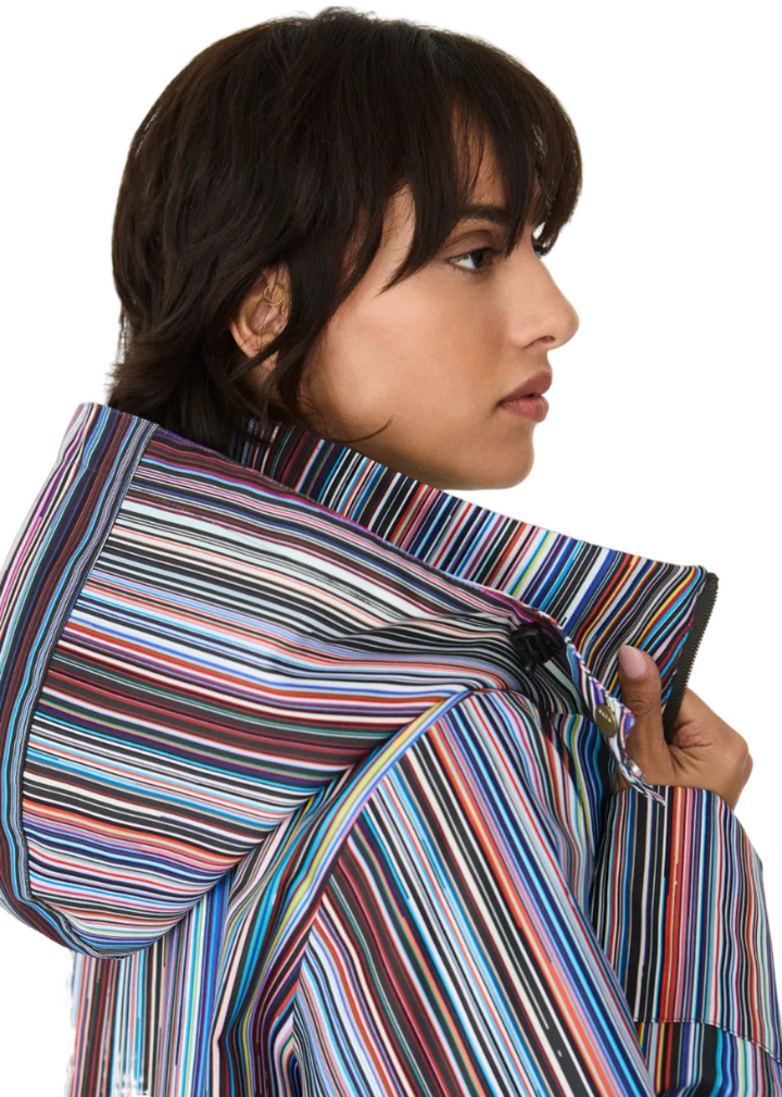 closeup of back hood of Model wearing the striped Kresua Jacket in grems by SKFK, a stylish knee-length raincoat
