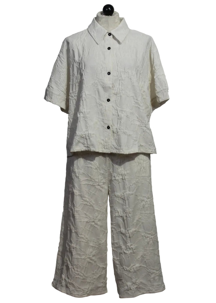 Resort white colored Princess Shirt by Kozan is a short sleeve textured button-up paired with the matching Amma Pant by Kozan 