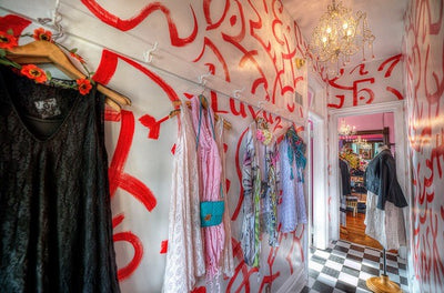 The back hallway and back entrance of the store with a fun whimsical red swirled wall over white