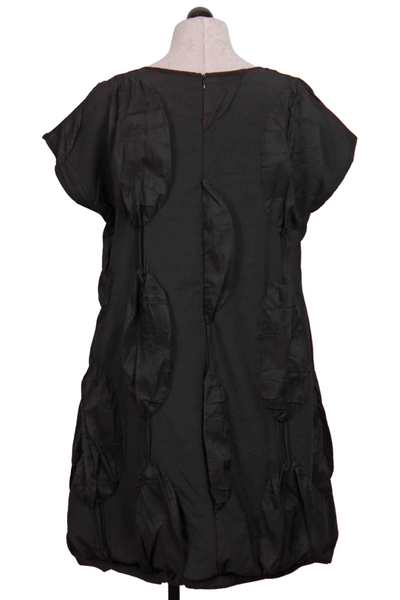 back view of black Simona Puffy Disc Dress by Kozan