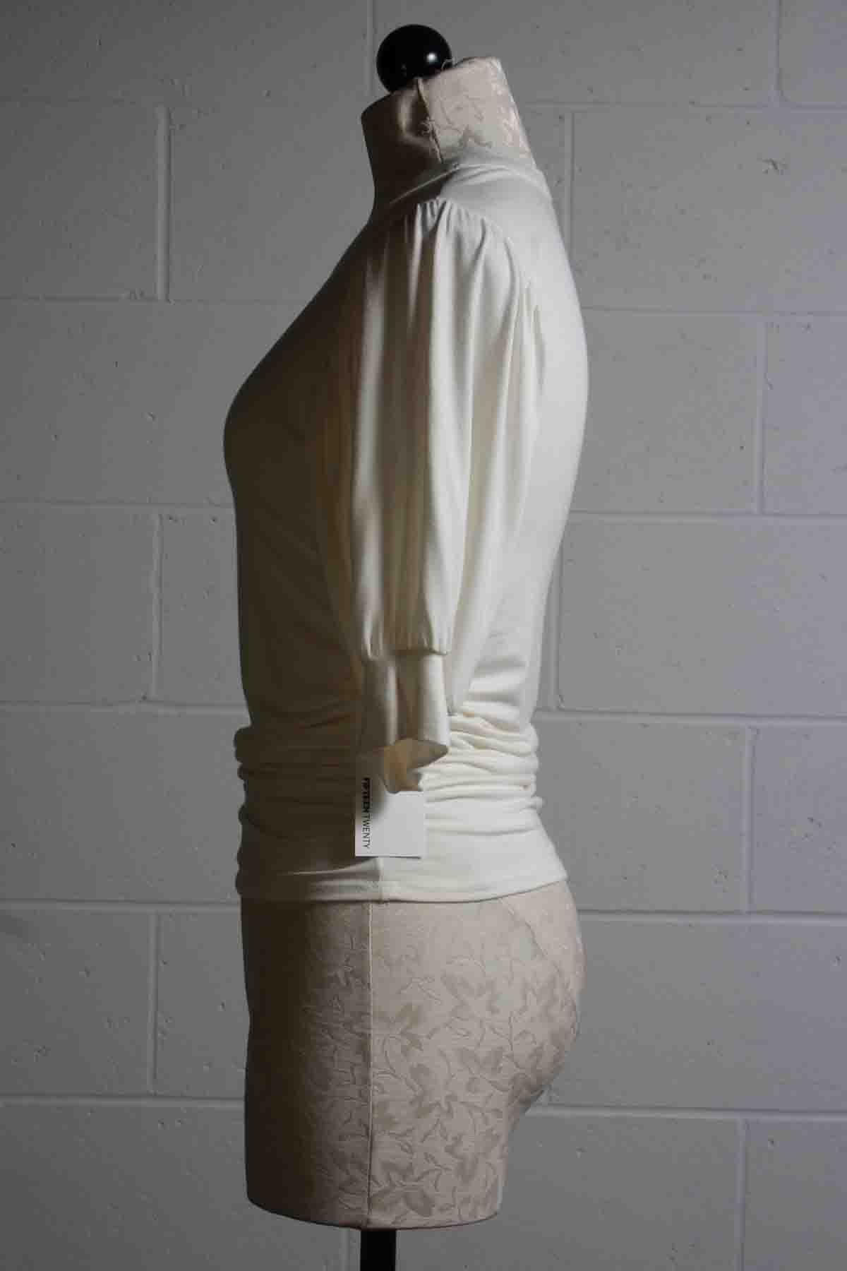 side view of cream Shirred Waist Puffed Sleeve Top by Fifteen Twenty