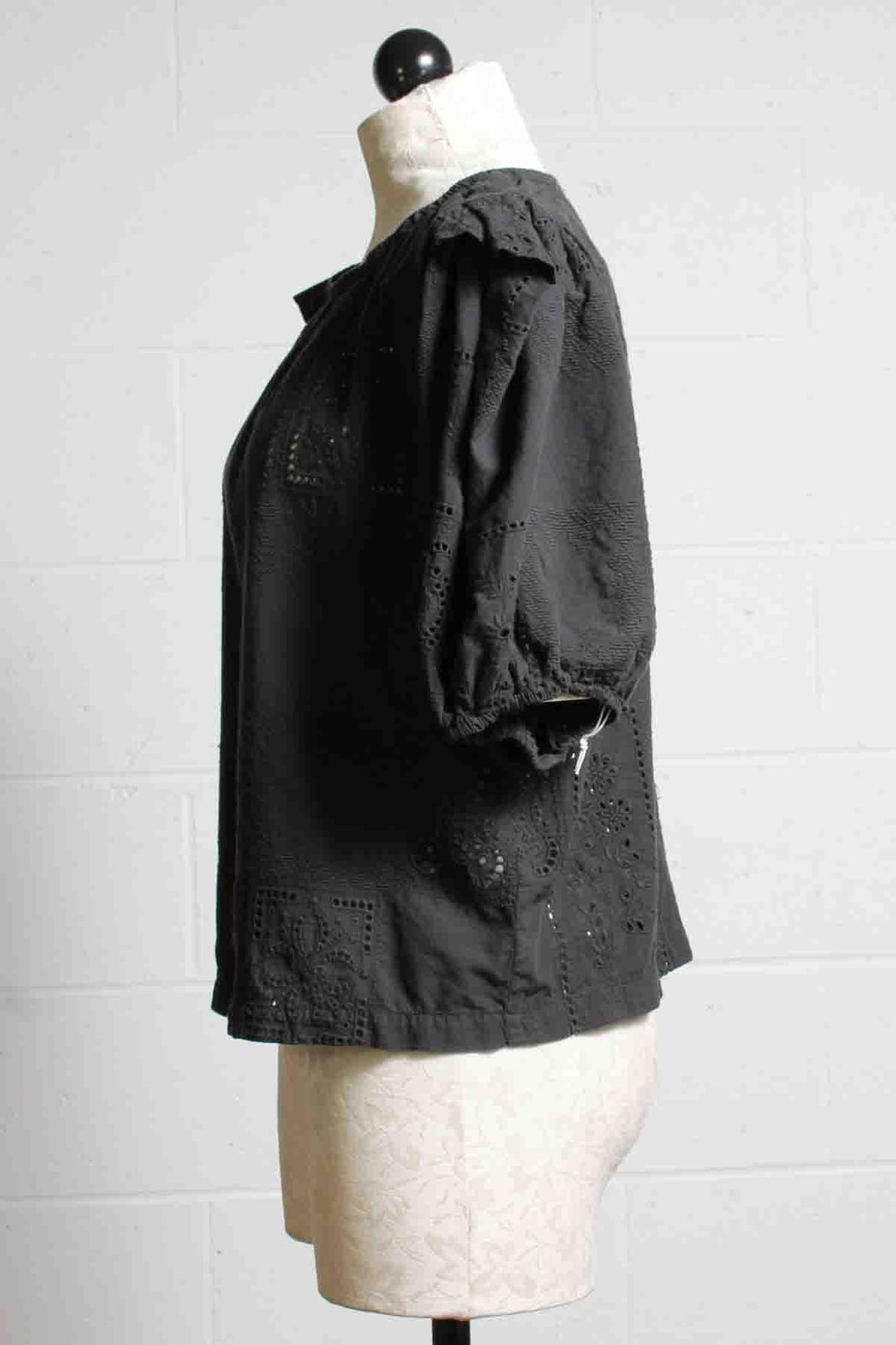 side view of Cotton Eyelet Embroidered Patchwork Carbon Blouse in Black by R.G. Kane with Puff Sleeves