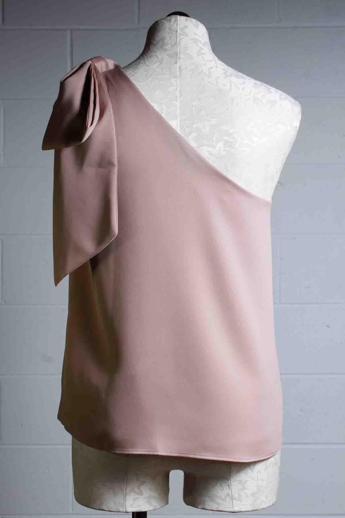 back view of one shoulder Khaki colored Warm Top by Trina Turk with a gorgeous bow draped over the other shoulder