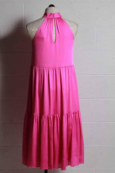 back view of fuschia sleeveless high banded neck tiered midi length dress