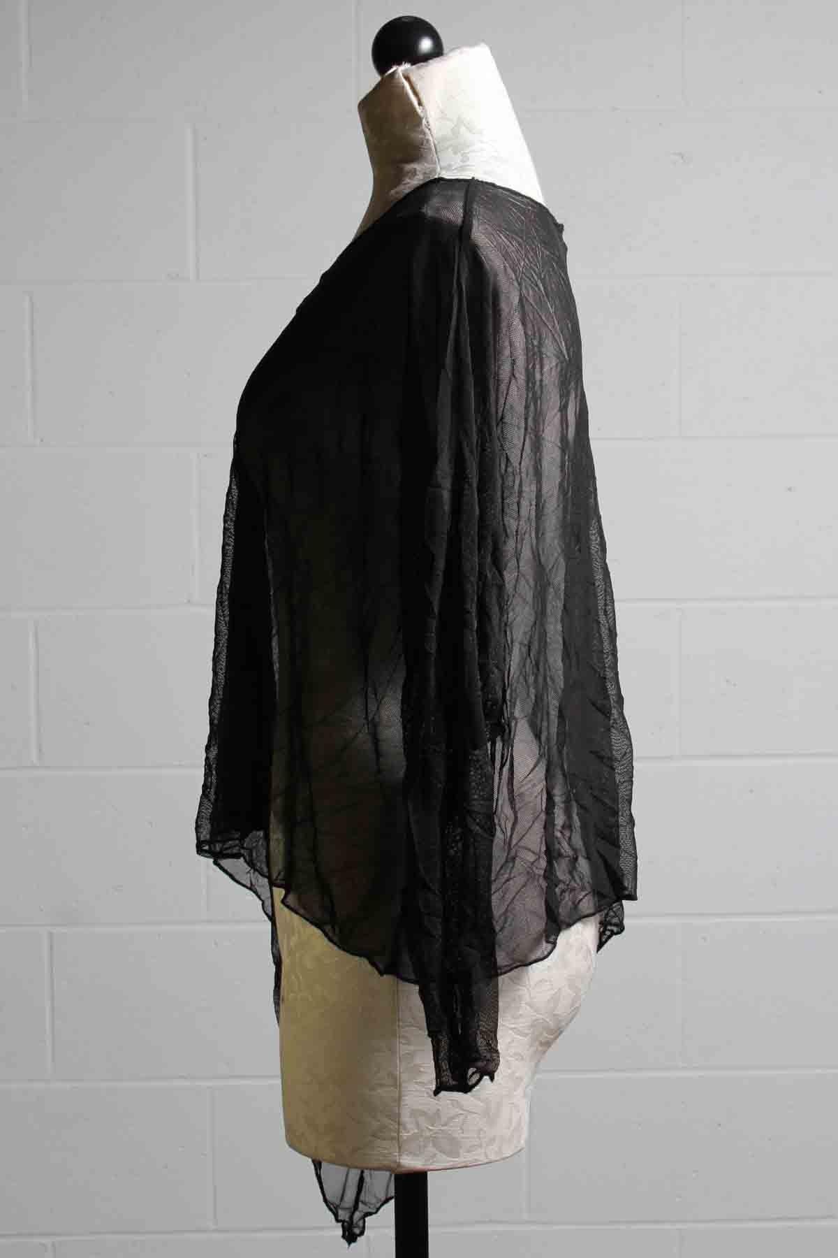 side view of Long Sleeved Solid Black Mesh Asymmetrical Hemline Topper by Reina Lee