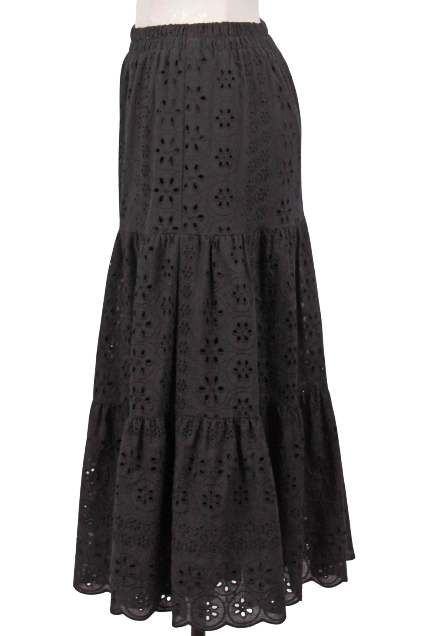 side view of black Tiered Eyelet Midi Length Skirt by Apricot with an elastic waist