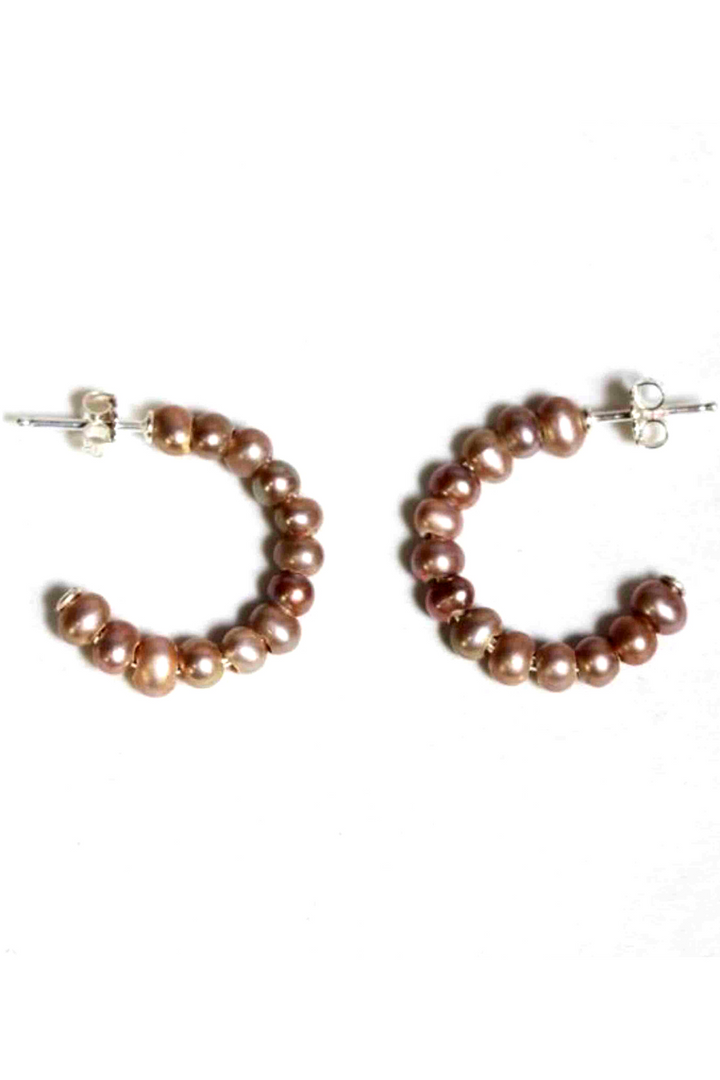 A classic hoop earring by Chan Luu in a taupe pearl