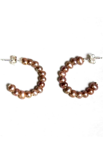 A classic hoop earring by Chan Luu in a taupe pearl