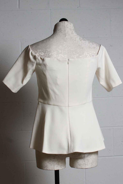 back view of ivory Elegant fitted Off the shoulder Forbid Top by Trina Turk with a peplum bottom