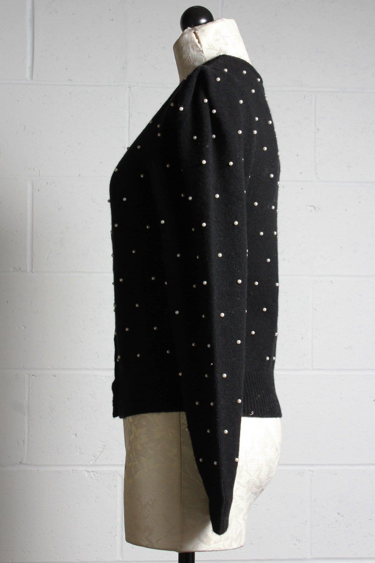 side view of black puffed ribbed sleeve cashmere blend cardigan with pearls and crystal buttons