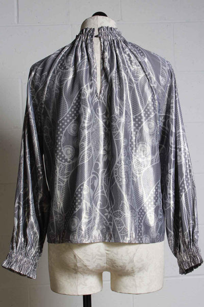 back view of high gathered elastic neckline top with elastic gathered cuffs in a silver with white print by Marie Oliver