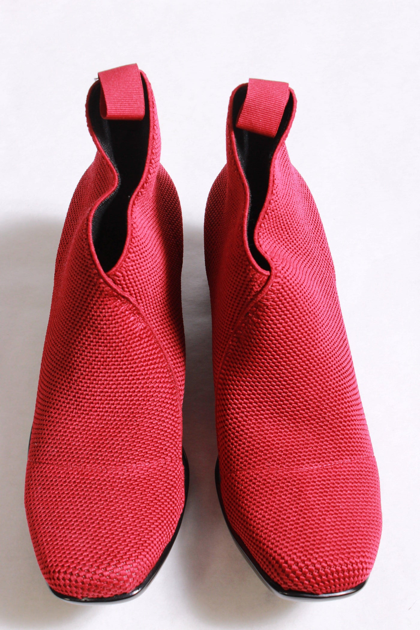 Cherry narrow lower wedge-like boot has a 2 1/4" rubber heel and an elastic pull tab upper