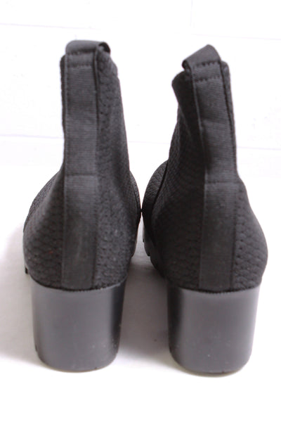 back view of black Platform bootie by Charleston Shoe Company with a rubber lug bottom sole and elastic upper