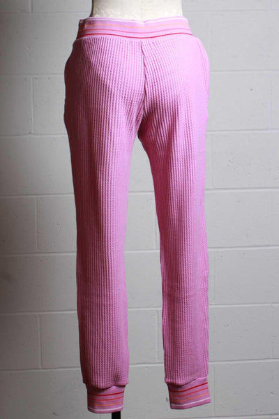back view of magenta ribbed thermal pant with a multi colored striped elastic waistband and ankle bands