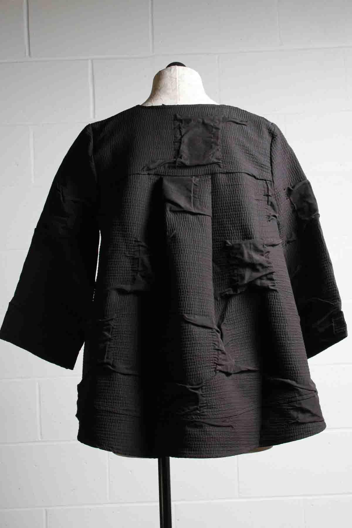 back view of Nero Squares Short flared Puckered Scarlett Jacket by Kozan