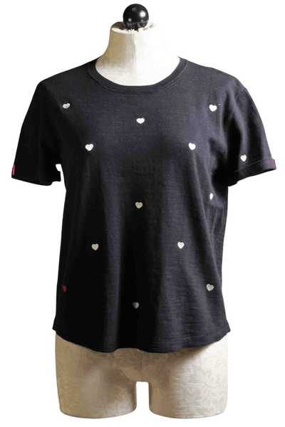 Black Show Me Love Top By Lisa Todd with White tiny hearts all over the front and sleeves and a tiny purple down on the bottom left