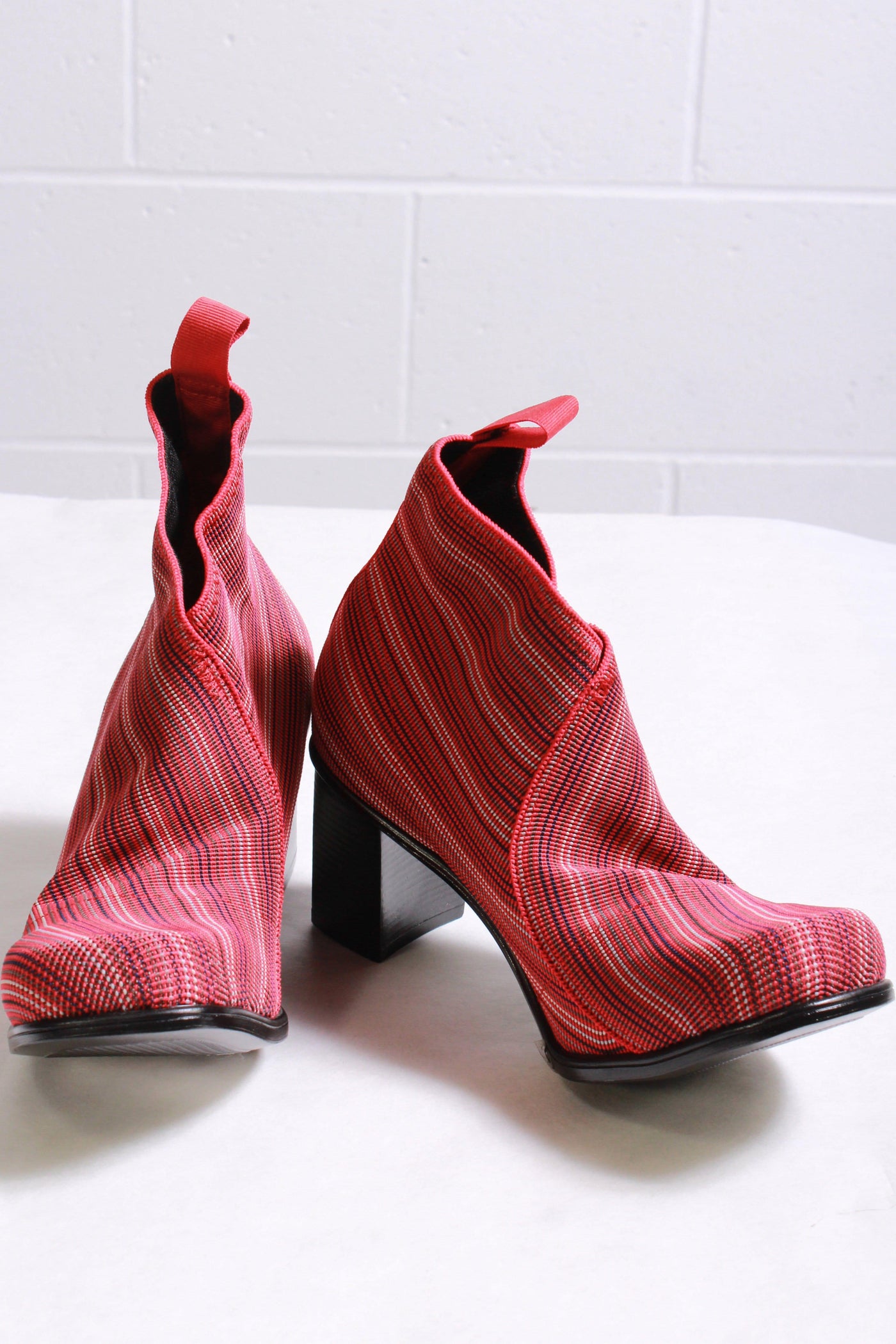side view of red stripe slip on style bootie with a stacked 2" rubber bottom heel and a stretch elastic upper with a pull back tab