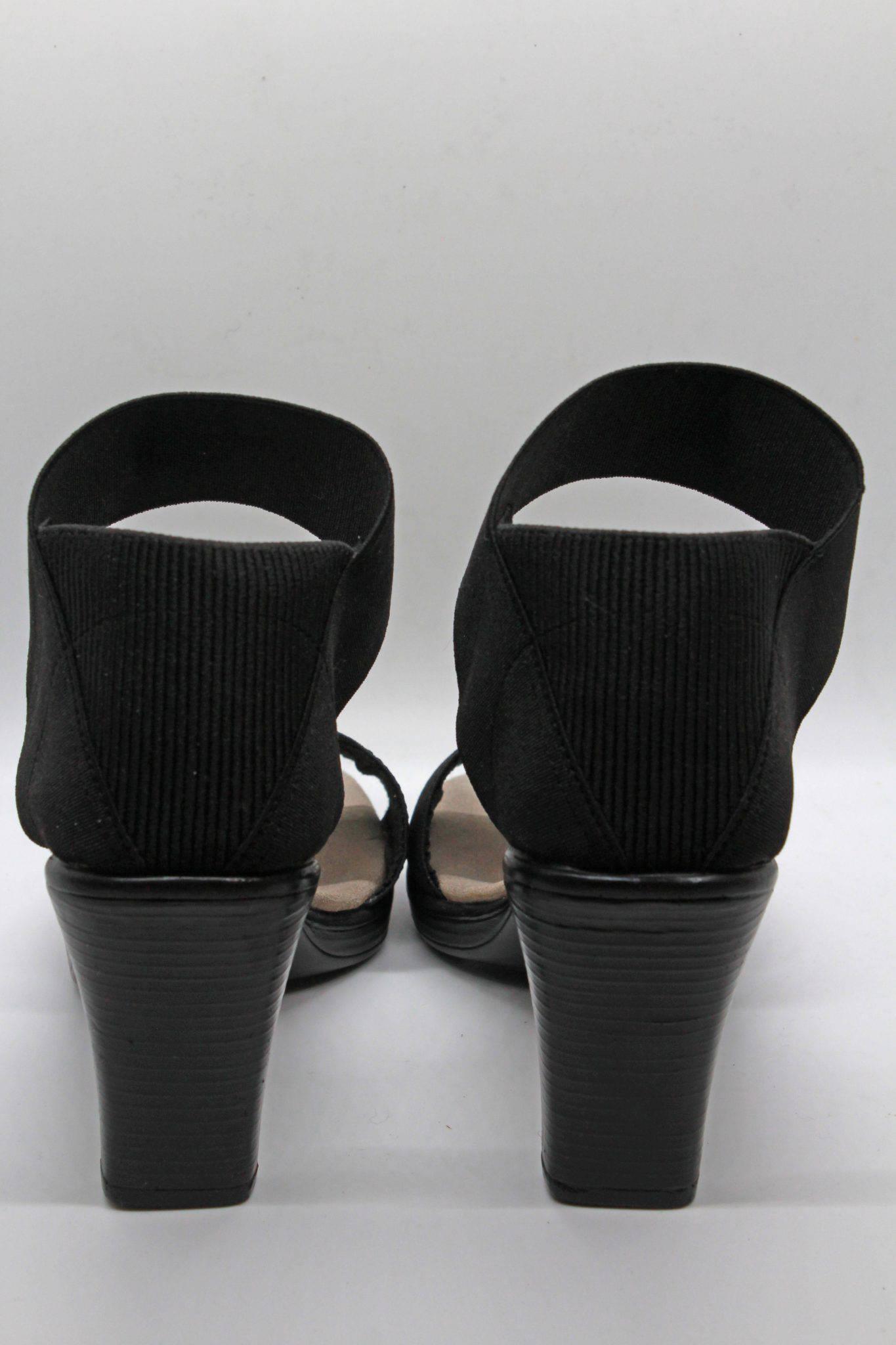 back view of black cocktail sandal by Charleston Shoes with a 3 1/2" heel and a wide stretch upper toe band and ankle straps with a closed back 