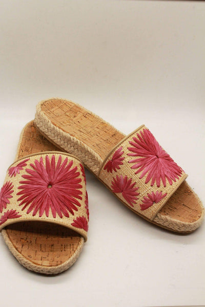 angled view of braided jute cork sole slides by Jack Rogers with pink hand woven rondelle flowers