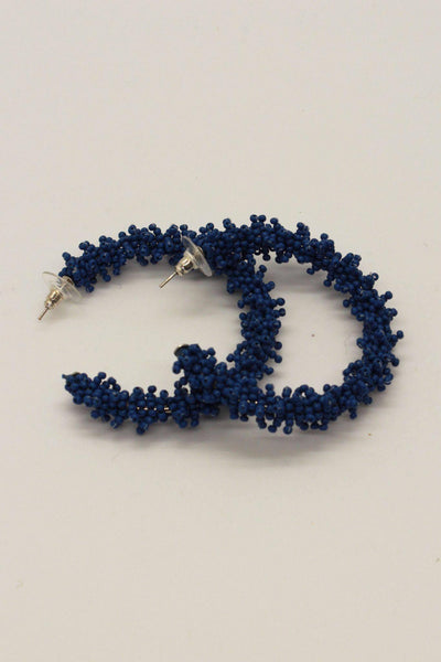 blue faux coral hoop with a brass post about 2" round.