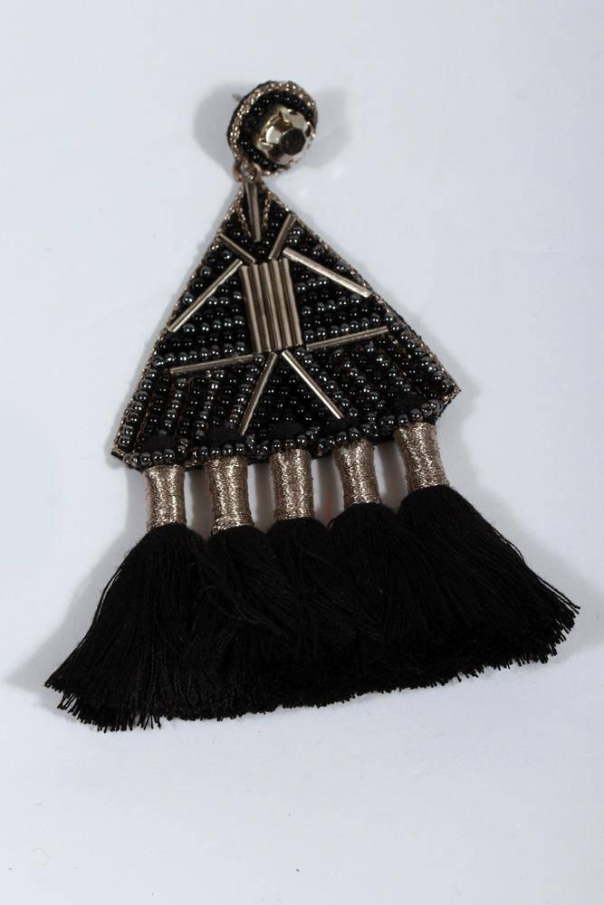 single earrings of beaded triangle with 5 tassels of black yarn hanging off.